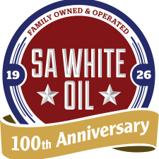 Circular SA White Oil logo with navy border, maroon center, 'Family Owned & Operated', two stars, and a gold ribbon reading '100th Anniversary'.